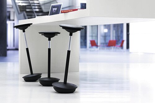 Stitz stools at high table in open workspace, informal meeting scene