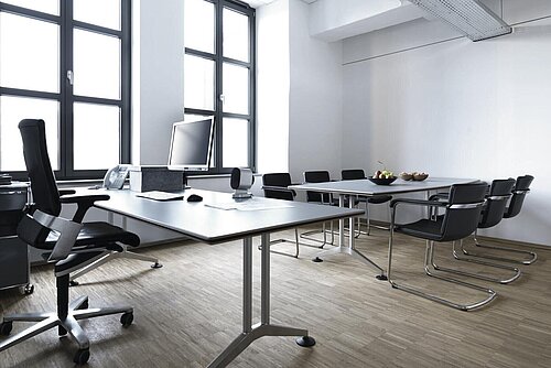 Logon table in conference room, meeting setup with office chairs