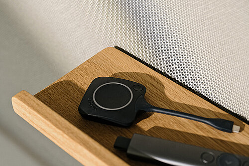 Confair Next media wall, integrated wooden shelf with power accessories, detail view