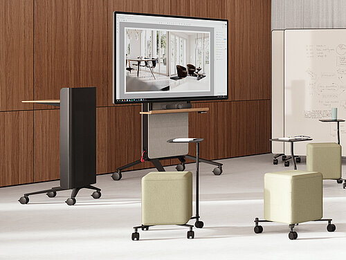 Confair Next mediawall with integrated display and shelves in front of curtains, front view