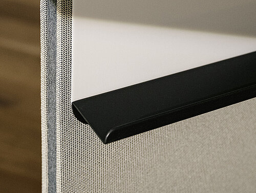 Confair Next media wall, upholstered panel edge with black trim, close-up view