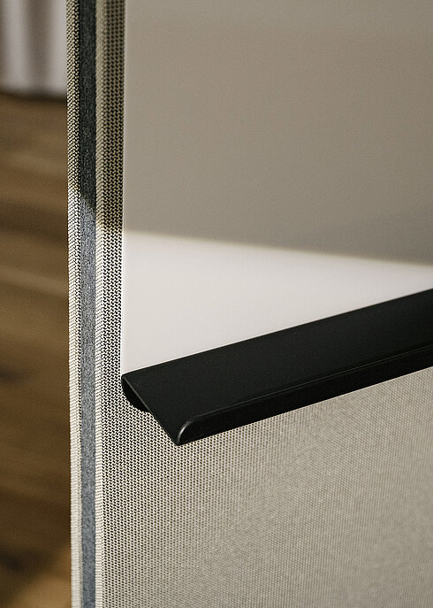 Confair Next media wall, upholstered panel edge with black trim, close-up view