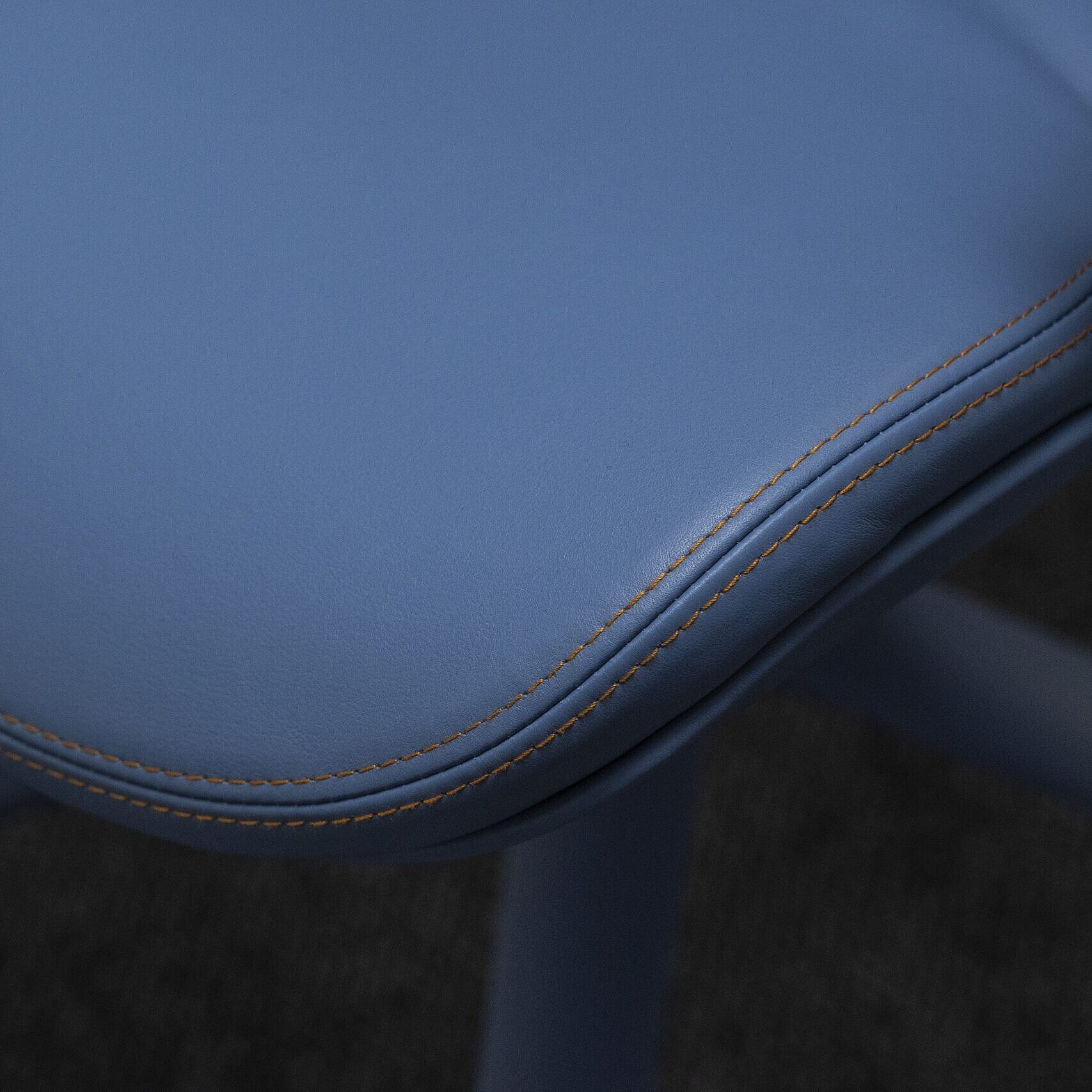 A close-up of an Intra chair with blue leather. The focus is on the seat.