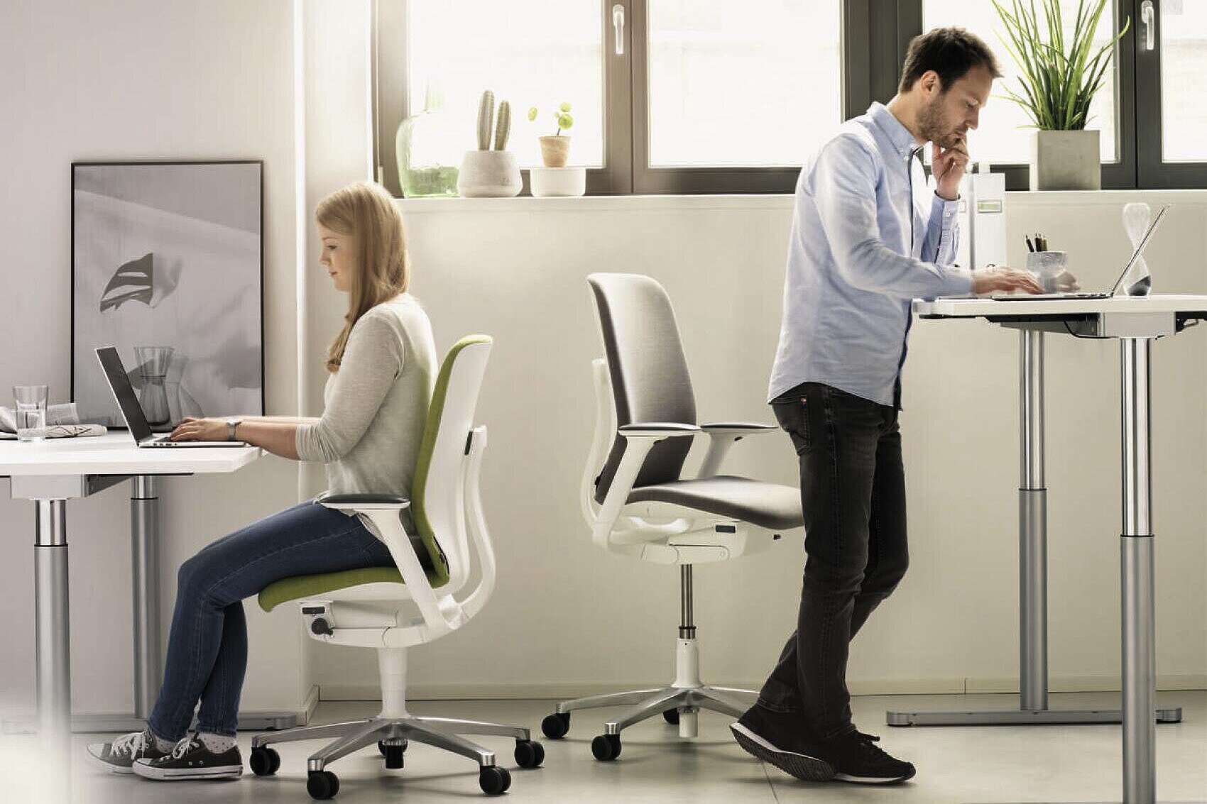 AT swivel chairs in modern office environment, mixed seated and standing workstation scene 