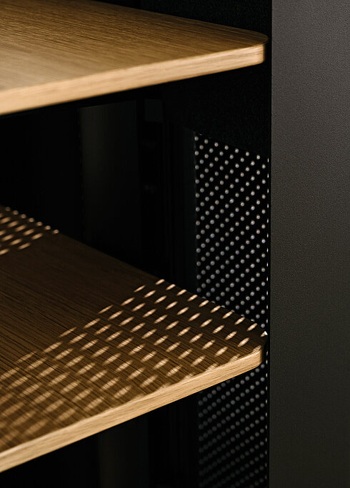 Confair Next lectern detail, close-up of perforated panel and wooden shelves