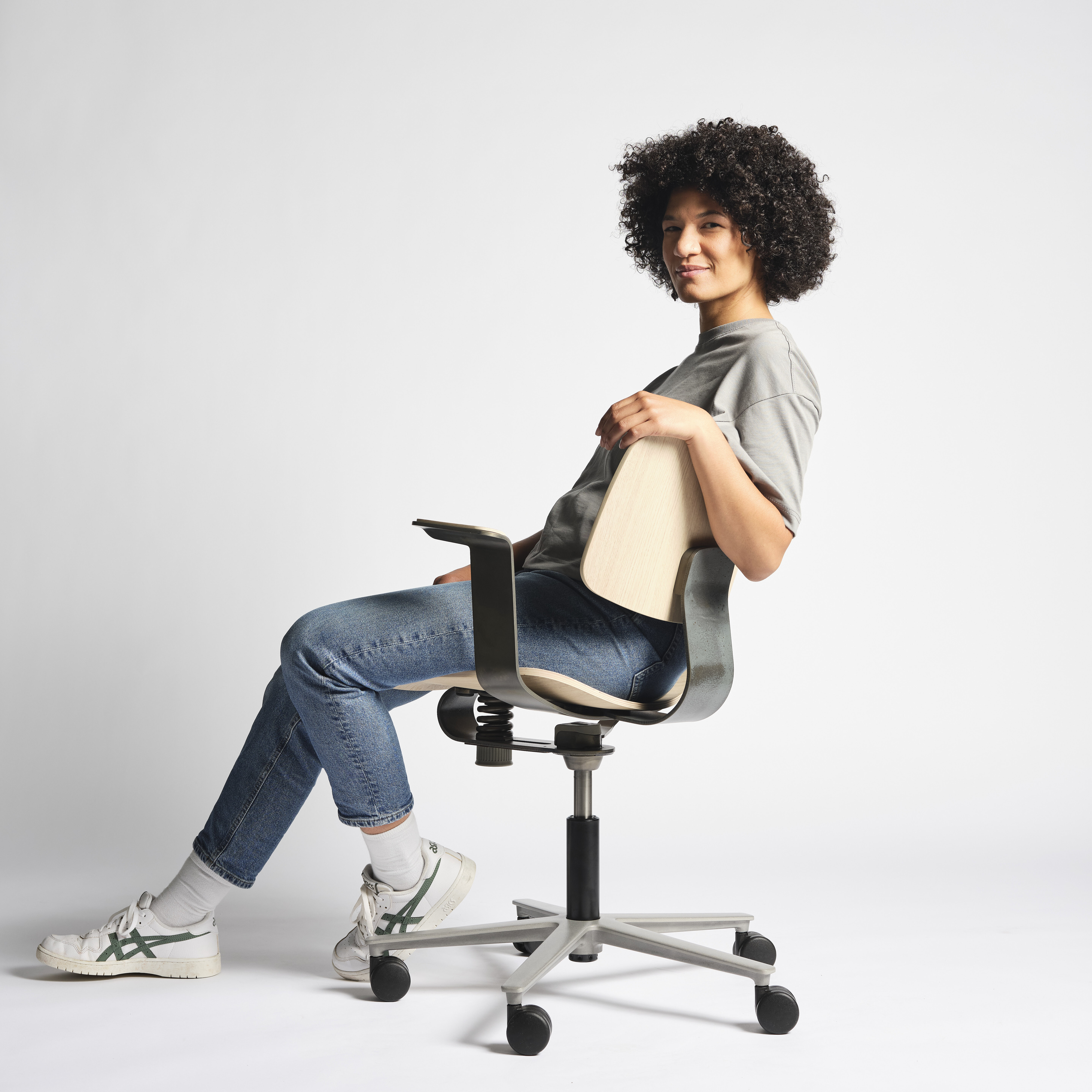 WiChair chair in studio setting, seated user demonstrating relaxed sitting posture