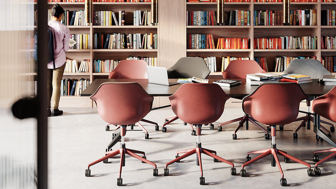 The bright library or study room is furnished with several Yonda chairs, shown here in warm shades of red and gray. The chairs blend seamlessly into the modern work environment and offer freedom of movement as well as exceptional comfort. The color-coordinated furnishings create an inspiring atmosphere for learning and working.