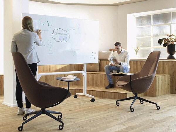 Yonda Lounge chairs with side table in meeting room, collaborative workspace scene