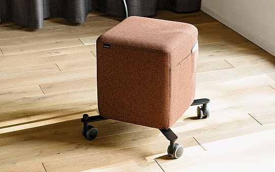 Confair Next upholstered rolling stool with side table
