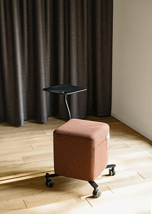 Confair Next upholstered rolling stool with side table