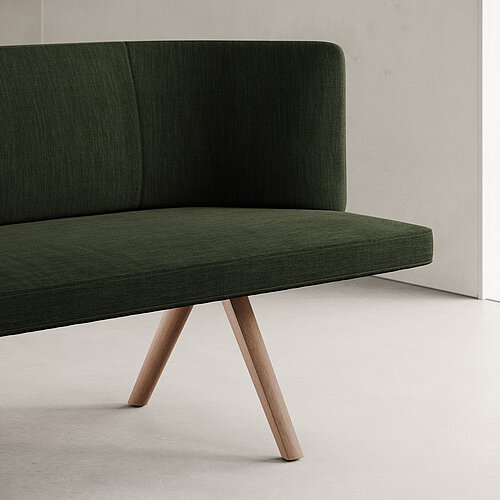 Insit bench, detail view, green upholstery and wooden legs