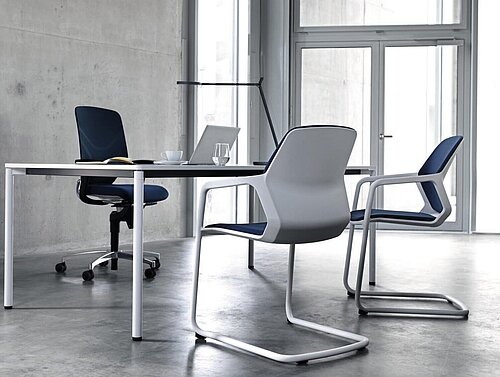 Metrik chairs at meeting table in modern office