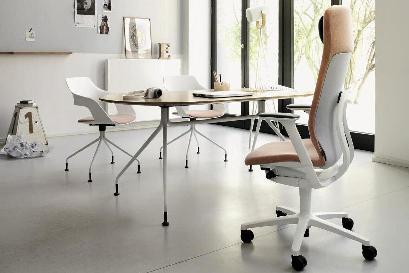 AT swivel chair in bright modern studio, collaborative meeting table scene with Occo chairs