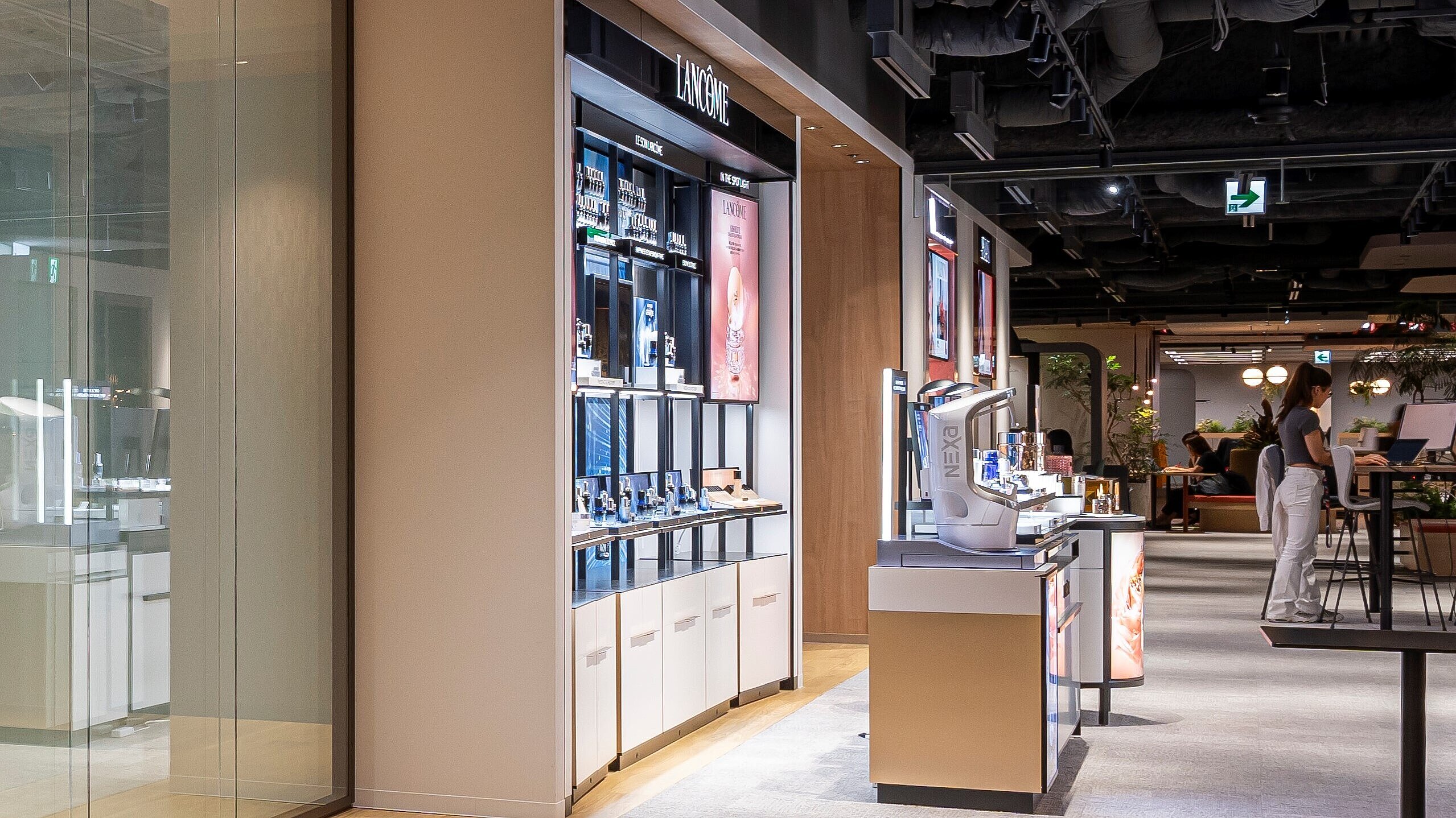 The picture shows a wall cabinet standing in a large room. This open wall cabinet contains various beauty products.