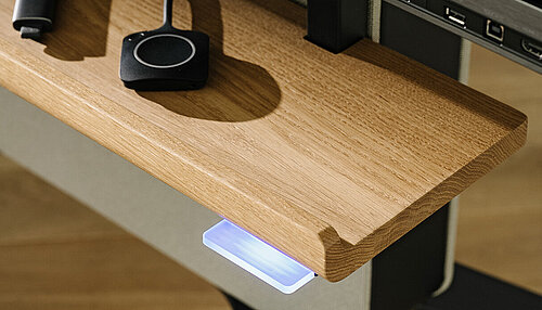 Confair Next media shelf detail with wooden tray and illuminated port