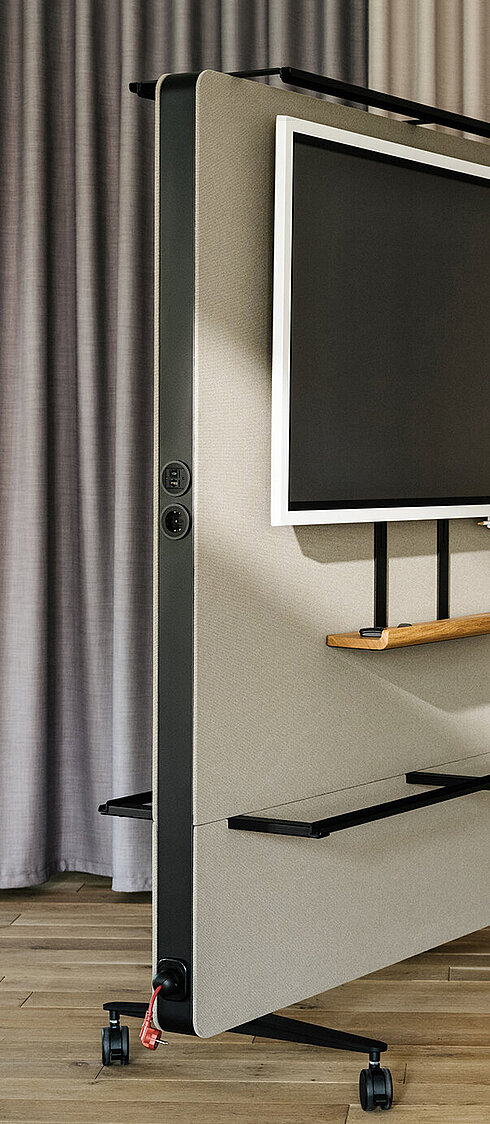 Confair Next mediawall in office environment with mounted screen and shelves