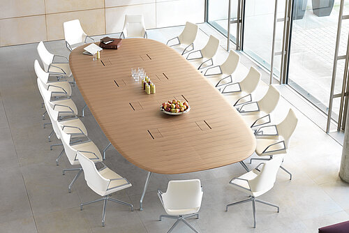 Graph chairs around conference table in bright meeting space