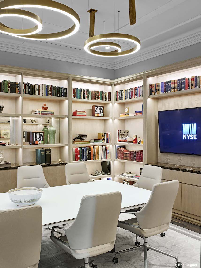 A bright conference room with white Graph chairs with low backrests and a white table arrangement.