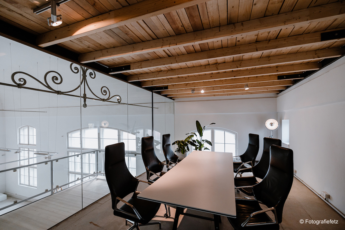 A conference room with black Graph chairs with high backrest