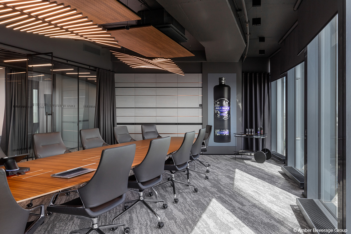 A conference room with a brown Graph table system and gray Graph conference chairs with medium-high backrests.