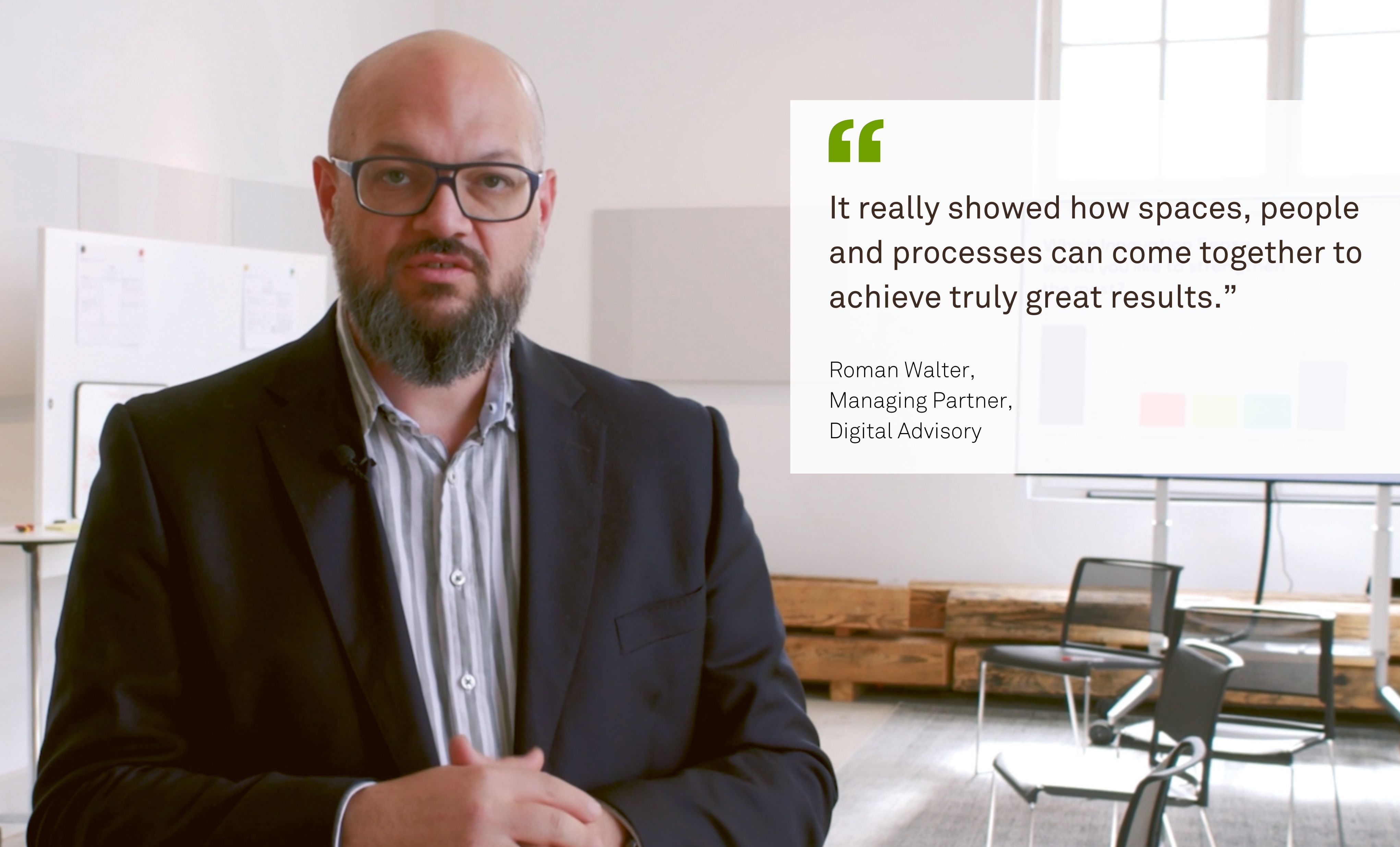 A man named Roman Walter from Digital Advisory is standing in a room with black lines visible in the background. Next to him is his quote: “It really demonstrated how space, people, and processes can be brought together to achieve truly great results.”