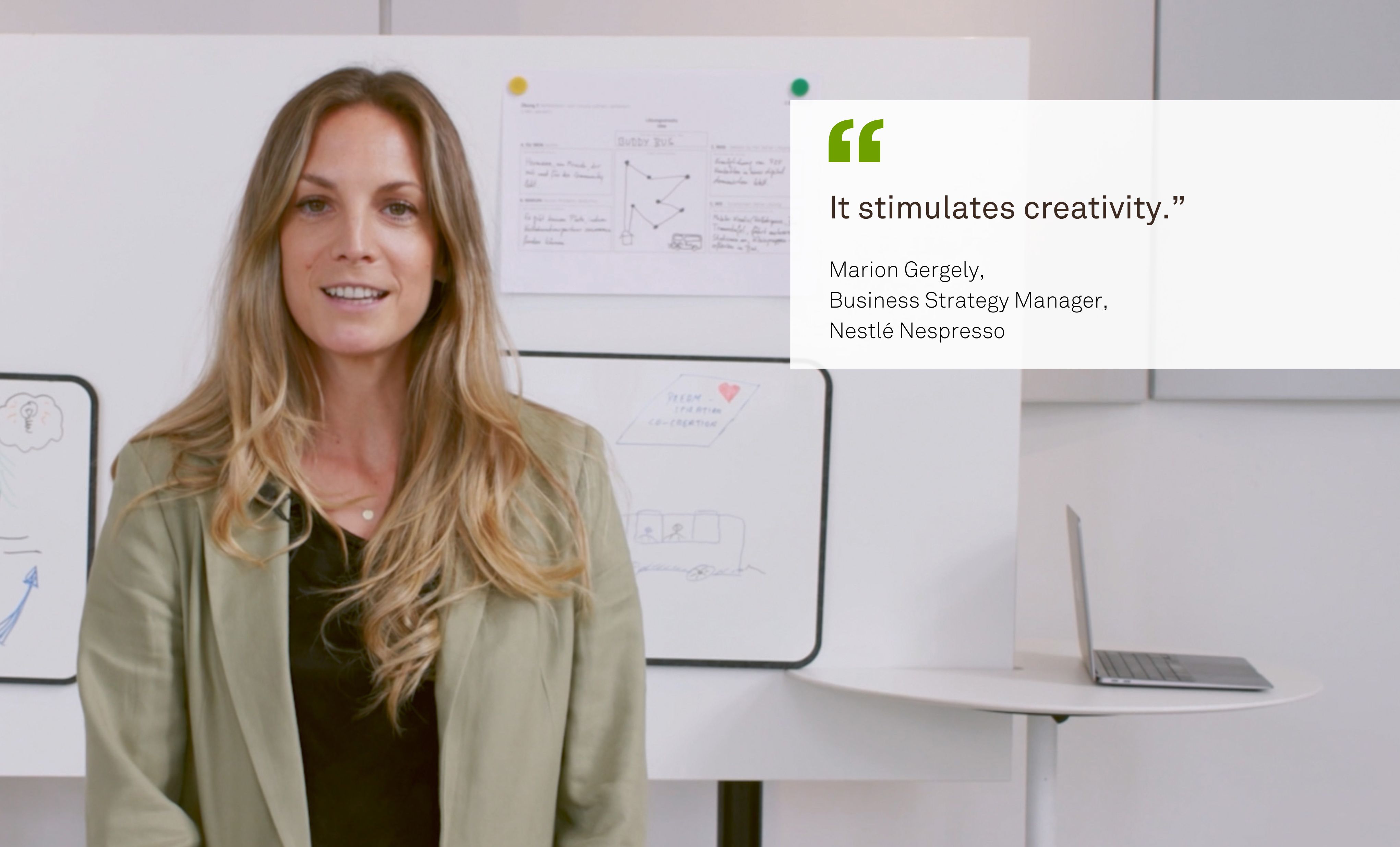 A blonde woman named Marion Gergely from Nestlé Nespresso stands in front of a Timetable Lift covered in notes and smiles at the camera. Next to her is a quote from her: “Stimulates creativity.”